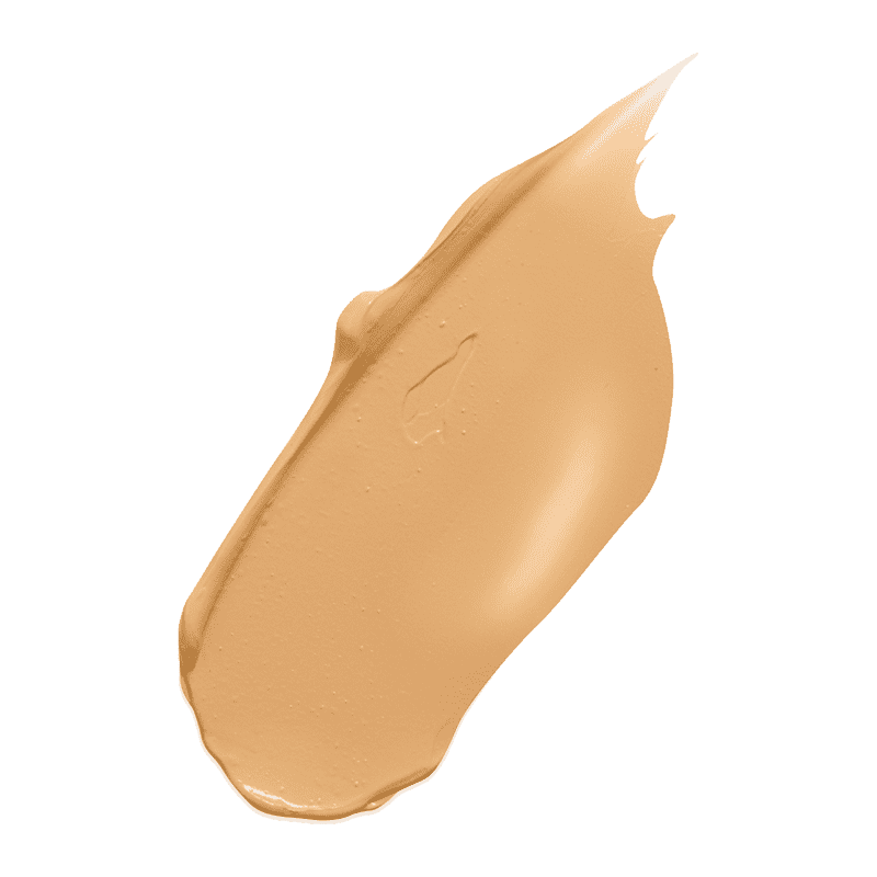 Beige Concealer-Swatch auf grünem Hintergrund.